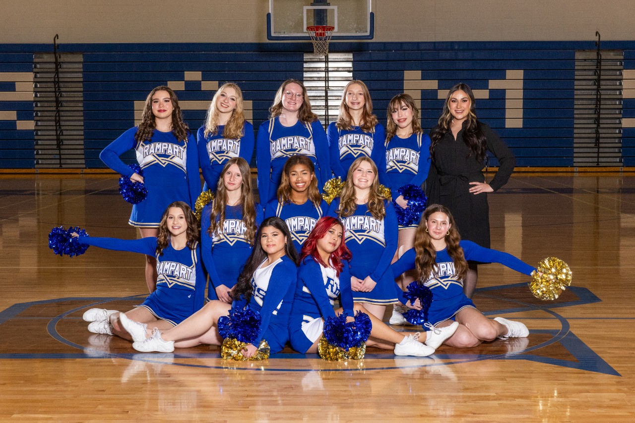 The RHS Cheer team poses for a picture on the gym floor.